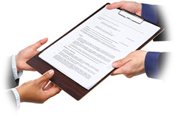 Hands handing off a résumé