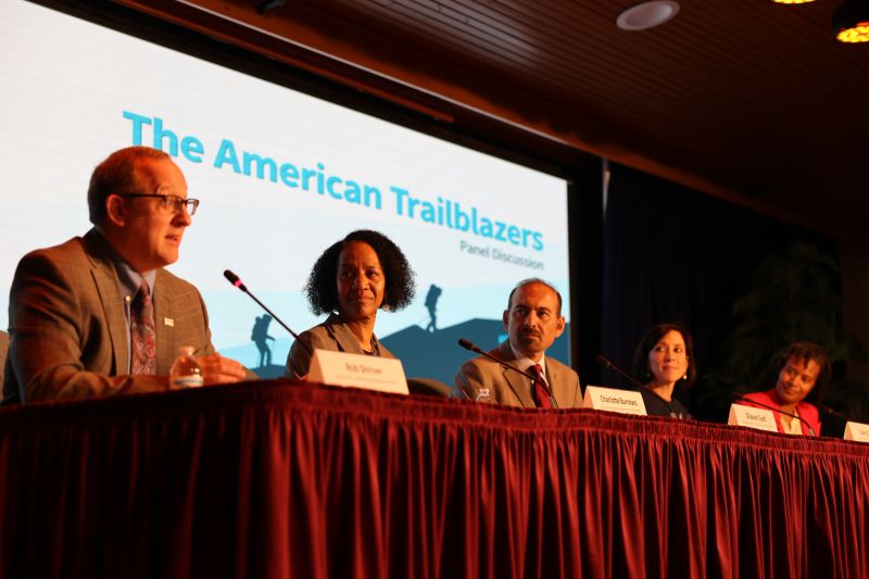 5 individuals sat at the table sharing pioneering journeys at OPM’s American Trailblazers Panel. Acting Director Shriver sat on the far left-hand side.